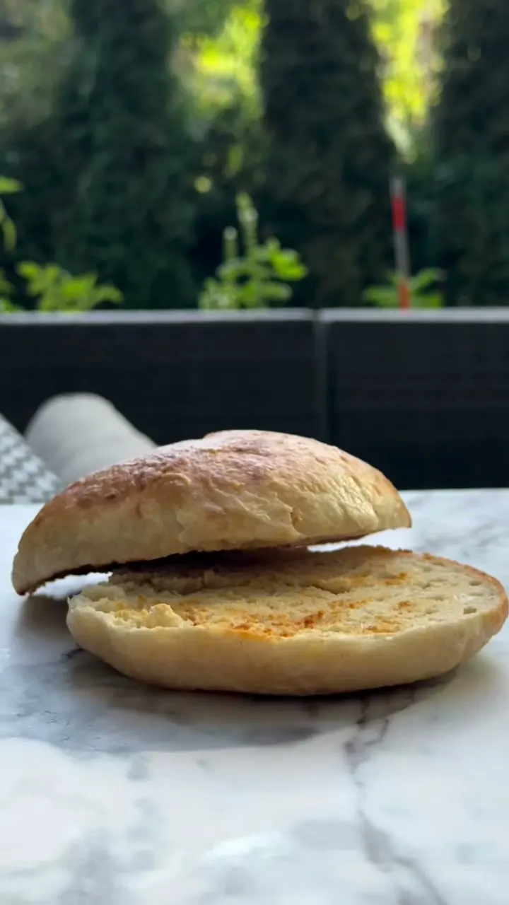 A sliced sourdough bagel on marble outdoors